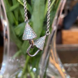 Silver necklace with diamond cut pendant.